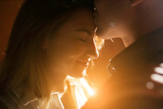 Dating Tips on How to Meet Women Fast | Image of Man Kissing Woman on Forehead with the Glowing Sunrise breaking in between them!